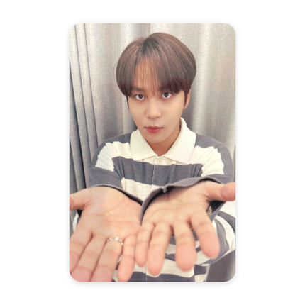 ATEEZ Jongho GOLDEN HOUR Part.5 pop-up reward photocard — brown hair with bangs, navy-and-white striped polo, both palms open and cupped toward the camera with a silver ring, gray curtain background.