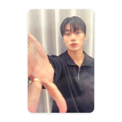 ATEEZ San GOLDEN HOUR Part.5 pop-up reward photocard — dark hair, navy half-zip pullover, silver ring, hand stretched toward the lens, gray curtain background.