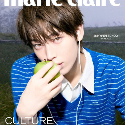 ENHYPEN Sunoo Marie Claire Korea November 2026 Cover E, Sunoo with light brown hair and white wired earphones holding a green apple to his lips, cobalt blue striped Prada V-neck sweater over a white collared shirt, misty field, white Marie Claire logo