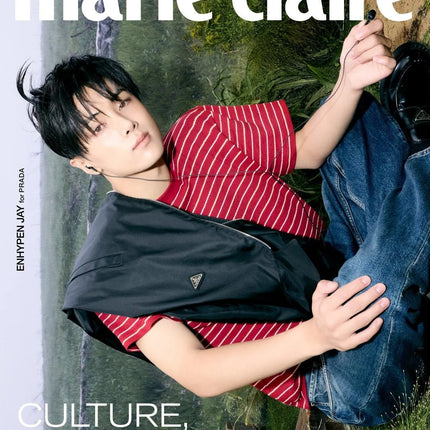ENHYPEN Jay Marie Claire Korea November 2026 Cover G, sideways shot of Jay lying in tall grass in a red pinstripe tee, black Prada vest, blue jeans and black loafers holding wired earphones, white Marie Claire logo