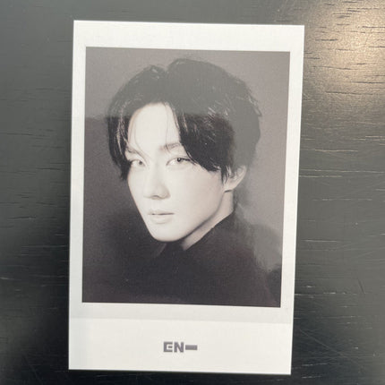 ENHYPEN Jungwon THE SIN VANISH Music Korea POB Polaroid — black and white dark hair black turtleneck face angled toward lens soft diffused lighting