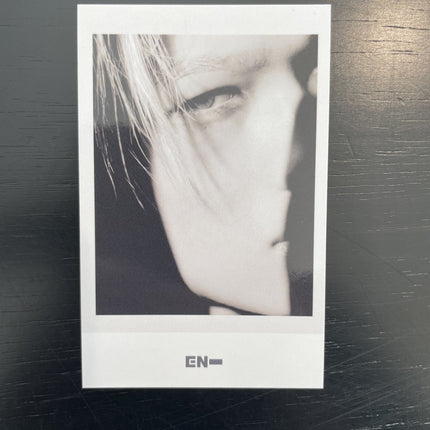 ENHYPEN Niki THE SIN VANISH Music Korea POB Polaroid — black and white curtain bangs hands pressed against translucent surface double exposure diagonal shadow