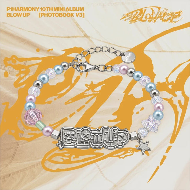 P1Harmony BLOW UP Bracelet – silver-tone BLOW UP logo plate with pastel blue and pink pearls, clear crystal beads, star charm and round P1H logo tag on the extender chain, on the 10th mini album Photobook V3 beige and gold background