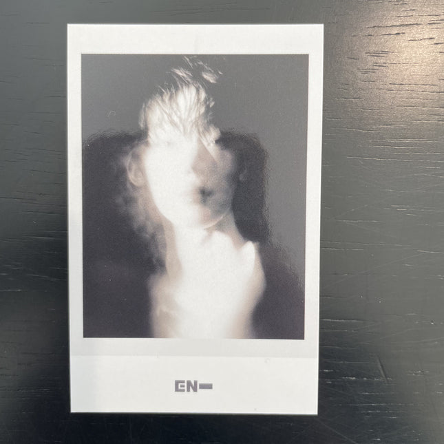 ENHYPEN Sunoo THE SIN VANISH Music Korea POB Polaroid — black and white motion blur ghost image figure in white dissolving into dark background