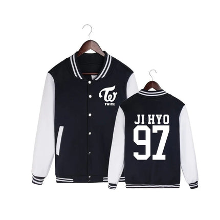 Black and white varsity jackets with 'TWICE' logo and name and number print on hangers against a white background.