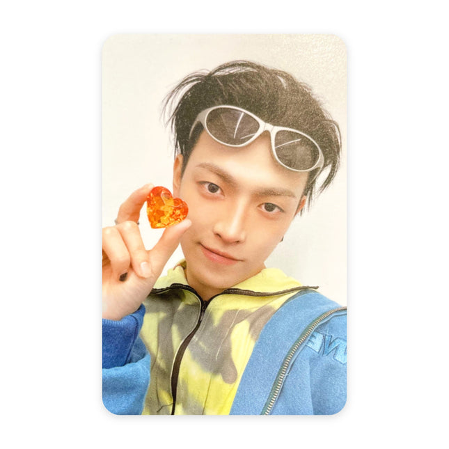 ATEEZ Hongjoong ANITEEZ IN COLOR Type B POB photocard — black hair with white wraparound sunglasses on his head, yellow tie-dye top and blue jacket, holding an orange jewel heart up to the camera