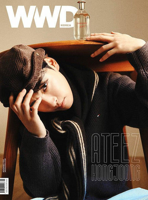 ATEEZ Hongjoong WWD Korea November 2026 Cover A – Hongjoong in a brown newsboy cap and dark knit, resting on a wooden chair beside a Tommy Hilfiger fragrance bottle, white WWD logo